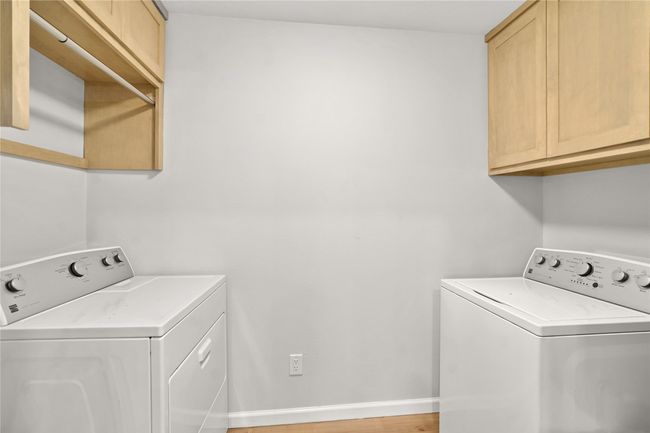 Washroom with separate washer and dryer and cabinet space | Image 25