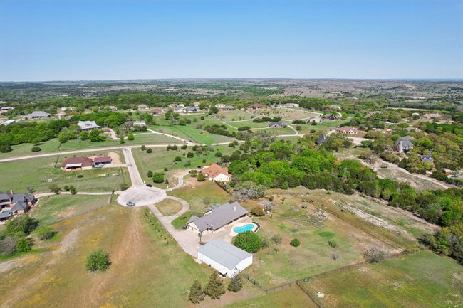 Separate fenced in area with running water for horses or animals on the right side. | Image 5