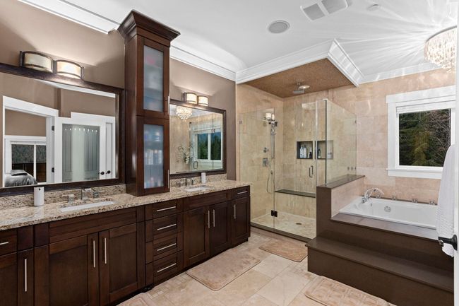 Ensuite bathroom with double vanity, a sink, a bath, and a shower stall | Image 23