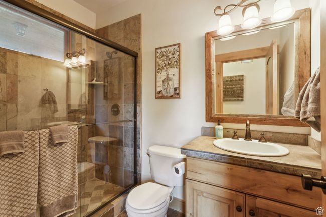 Bathroom featuring vanity, toilet, and a shower stall | Image 17