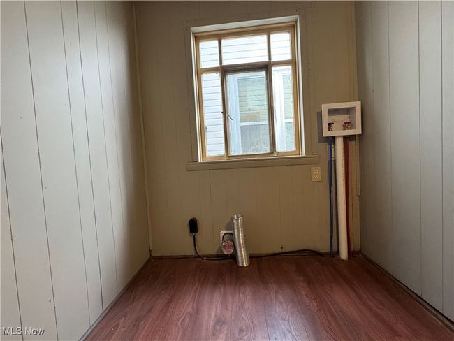 Spare room featuring wood finished floors | Image 7