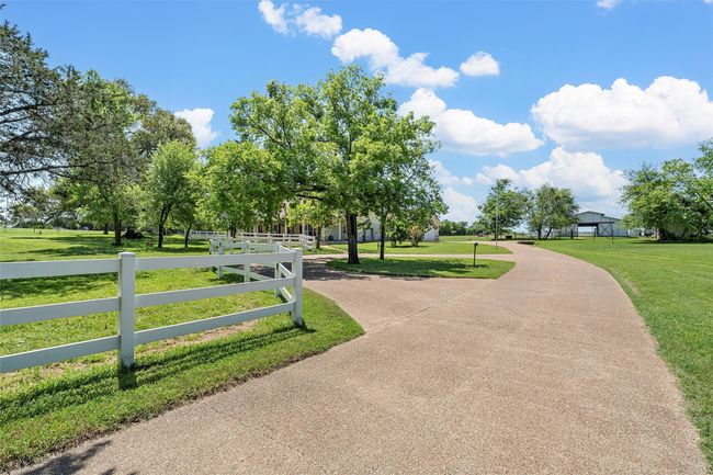 View of home's community with fence and a lawn | Image 6