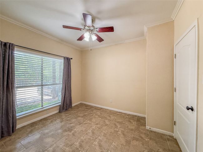 Spare room with a ceiling fan and ornamental molding | Image 18