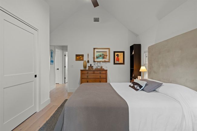 Bedroom with light wood finished floors, high vaulted ceiling, and a ceiling fan | Image 34