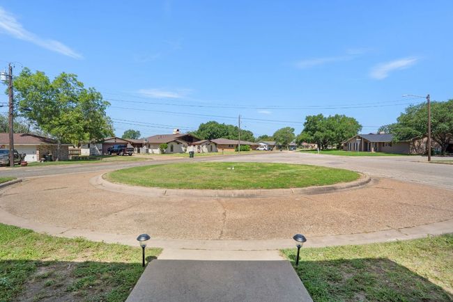 View of grassy yard featuring a circle driveway | Image 33