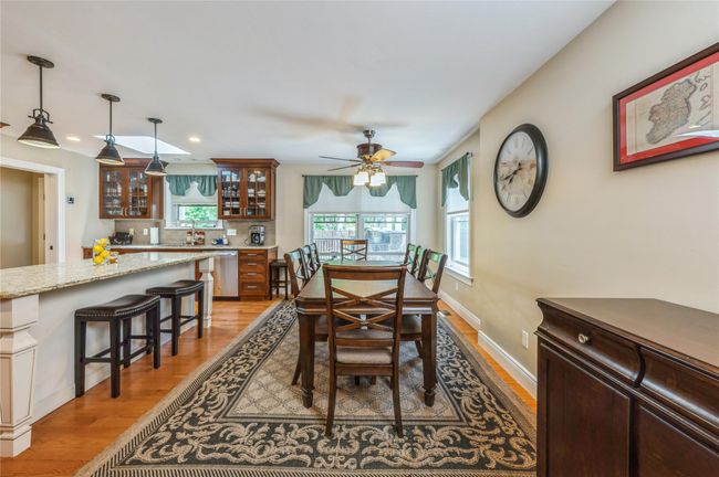 Dining area featuring light wood-style floors, a ceiling fan, and recessed lighting | Image 4