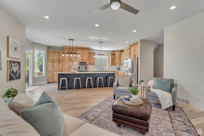 Living area featuring recessed lighting, light wood-style flooring, and ceiling fan | Image 7