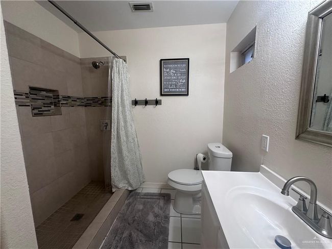 Bathroom with tile patterned flooring, vanity, toilet, and walk in shower | Image 9