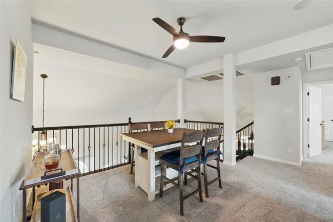 Dining space with ceiling fan, attic access, carpet floors, and lofted ceiling | Image 30