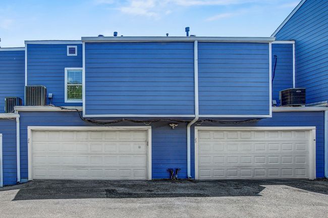 Back of property with a garage and central AC unit | Image 25