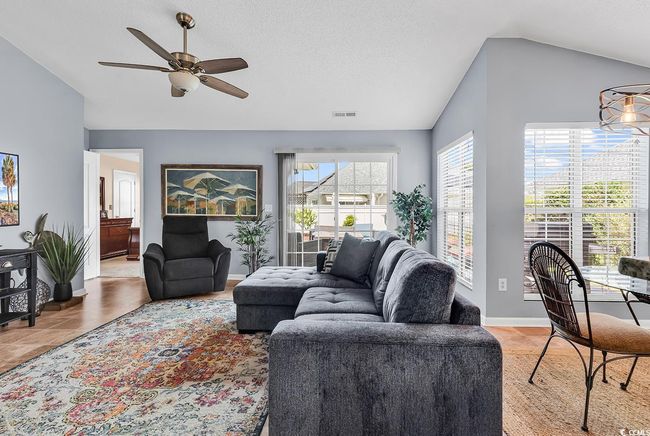 Living room featuring vaulted ceiling and ceiling fan | Image 12