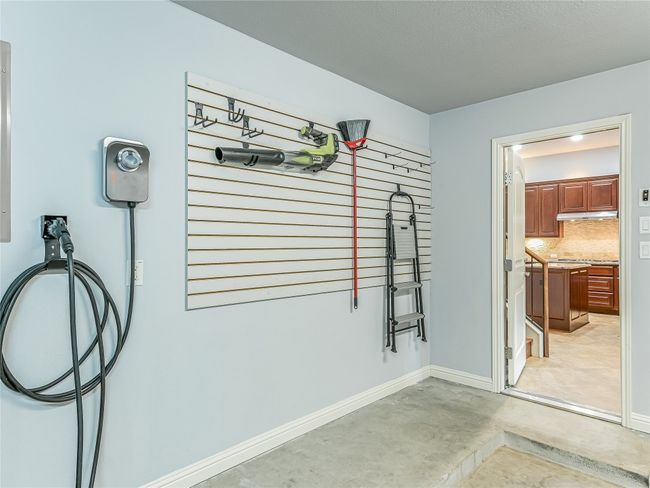 Enjoy the convenience of an installed EV charger mounted to the back wall of your garage. | Image 31