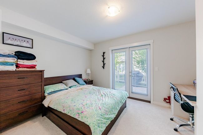 Bedroom with access to exterior, light colored carpet, and french doors | Image 27