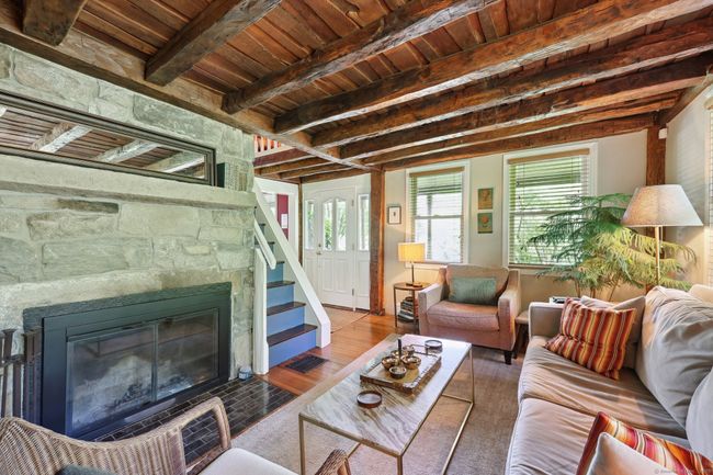 Fieldstone fireplace with glass doors. | Image 5