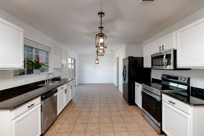 2nd dining area featuring visible vents, washer / clothes dryer, an inviting chandelier, and a decorative wall | Image 16