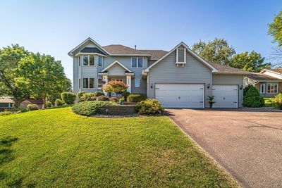 This impeccably-maintained four bedroom, four bathroom home is close to Sand Point Beach and the boat launch, and offers a park-like backyard setting with beautiful views. | Image 3