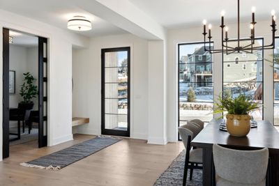 Step into luxury and warmth as you enter our bright foyer. Bathed in natural light streaming through the windows, this inviting space sets the tone for the rest of the home. | Image 2