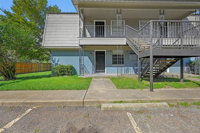 View of front of house with a porch, stairway, brick siding, and a balcony | Image 18