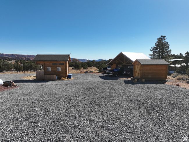 View of yard with a storage shed, an outdoor structure, and a mountain view | Image 13