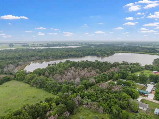 Aerial view featuring a wooded view and a water view | Image 7