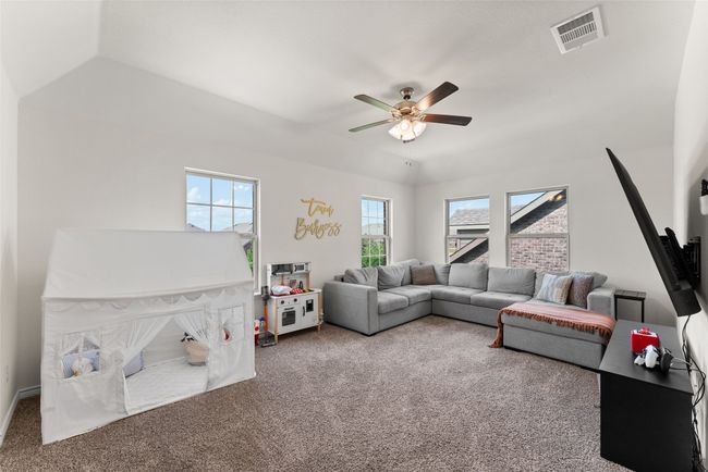 Carpeted living room featuring a ceiling fan | Image 27