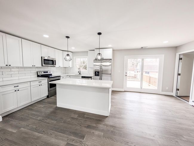 Kitchen with a wealth of natural light, tasteful backsplash, stainless steel appliances, and a sink | Image 5