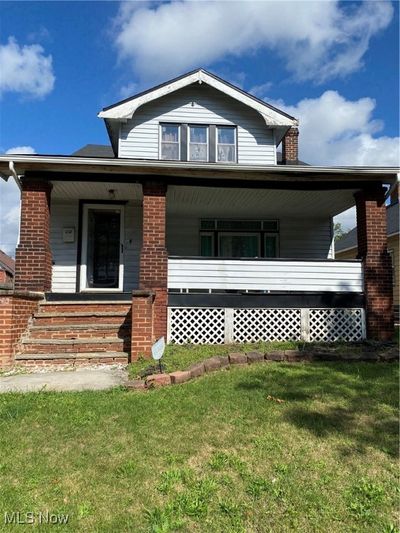 View of front of house with covered porch and a front yard | Image 2