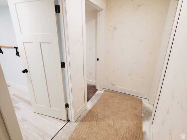 Hall featuring a textured ceiling and baseboards | Image 24