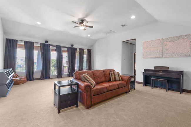 Living area featuring lofted ceiling, light carpet, ceiling fan, recessed lighting | Image 20