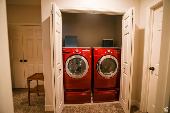 Laundry room with independent washer and dryer and carpet flooring | Image 57