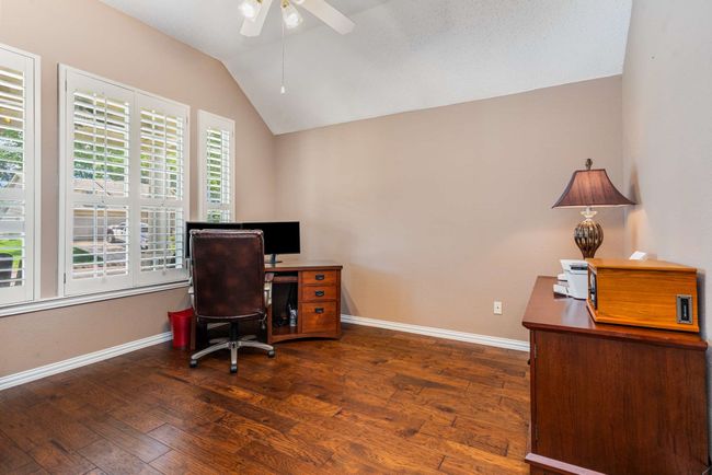Office space featuring ceiling fan, vaulted ceiling, hardwood / wood-style flooring, and baseboards | Image 11