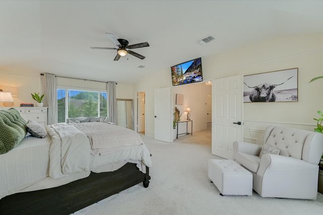 Bedroom with lofted ceiling, light colored carpet, and ceiling fan | Image 19