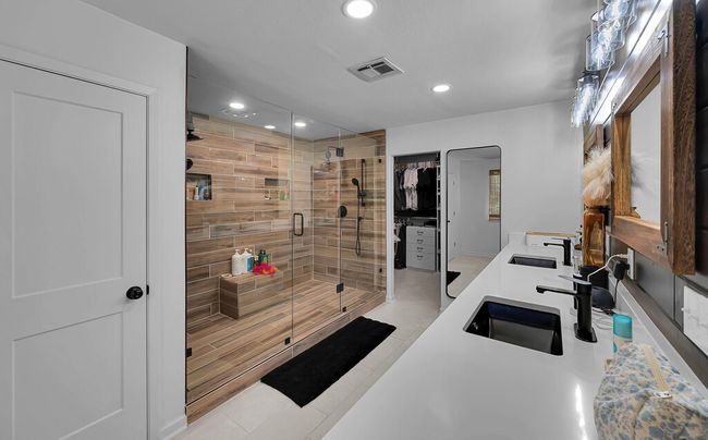 Full bathroom with recessed lighting, double vanity, a stall shower, a spacious closet, and tile patterned flooring | Image 17