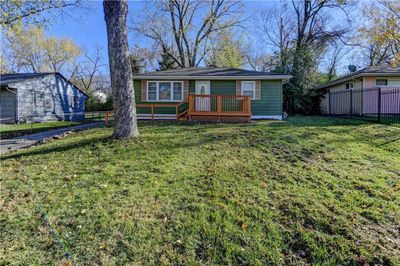 Single story home featuring a deck and a front lawn | Image 2