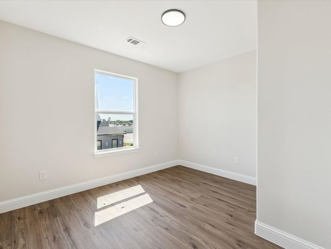 Empty room featuring baseboards, wood finished floors, and visible vents | Image 21