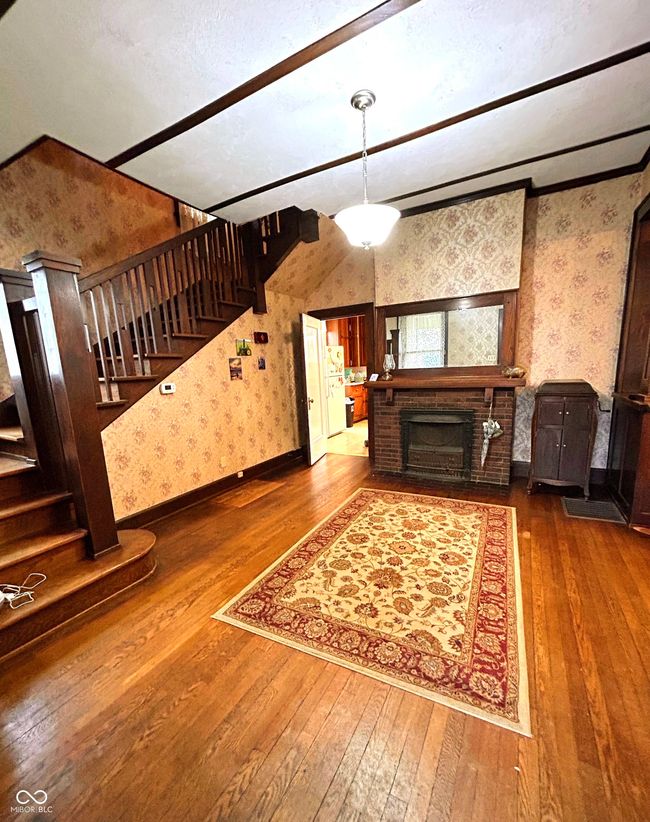 Large Foyer with Fireplace, Open Stairs and Hardwood Floors | Image 7