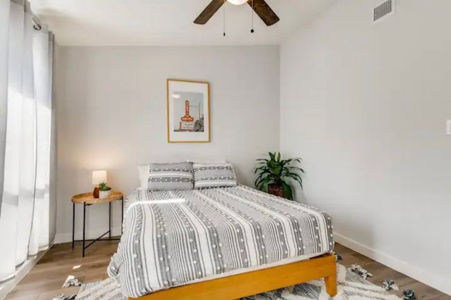 Bedroom with baseboards, wood finished floors, and ceiling fan | Image 20
