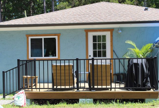 Back of house featuring roof with shingles and stucco siding | Image 18