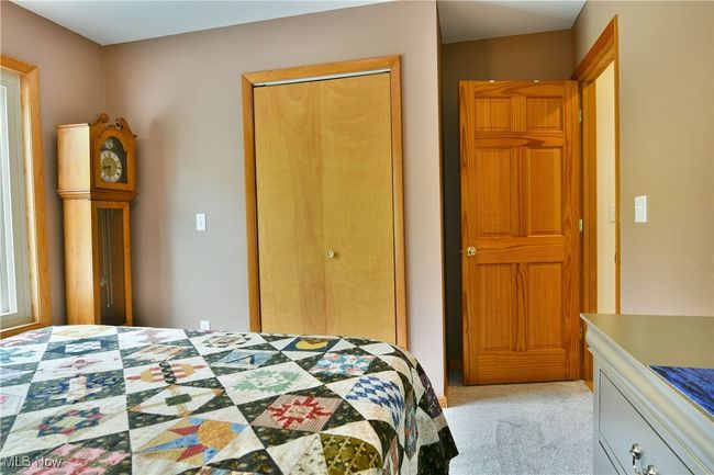 Bedroom with a closet and light colored carpet | Image 17