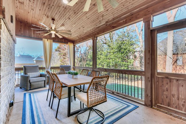 Amazing outdoor living. This covered, screened patio is the perfect place to enjoy a summer supper with guests or savor your morning coffee. | Image 47