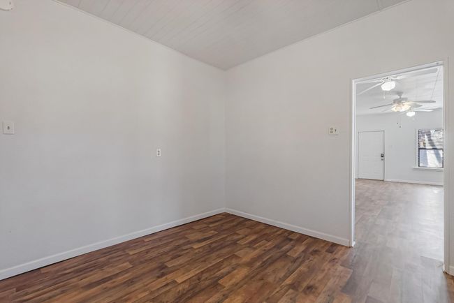Empty room with dark hardwood / wood-style floors and ceiling fan | Image 22