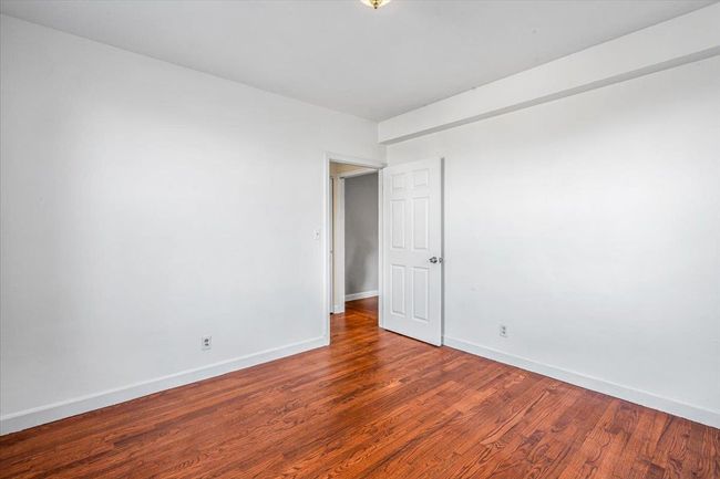Bedroom with hardwood / wood-style flooring | Image 13