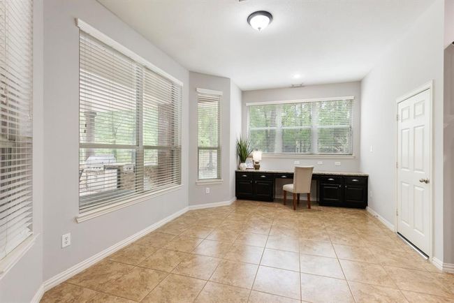 Breakfast room with buffet area or workspace. Door on right to single car garage. | Image 17