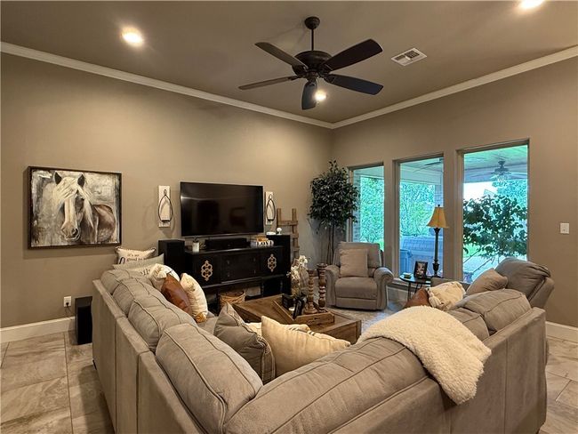 Living room with a ceiling fan, crown molding, and recessed lighting | Image 5