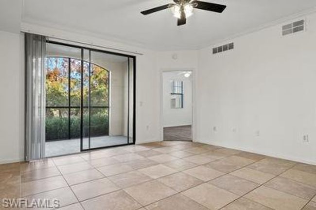 Unfurnished room with light tile patterned floors, visible vents, baseboards, and ceiling fan | Image 8
