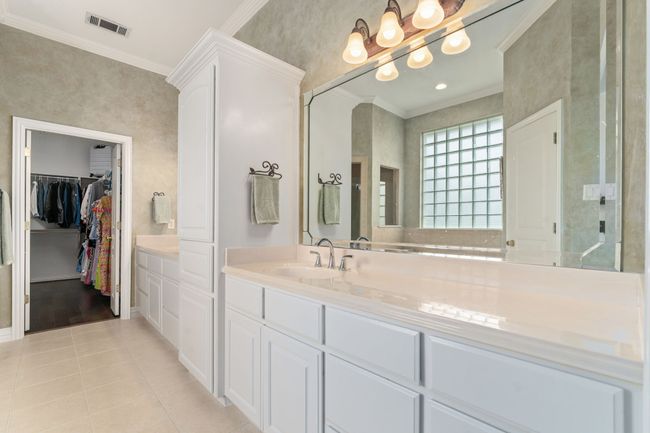 Double vanity, storage galore, beveled framed mirrors, and decorative lighting! | Image 17
