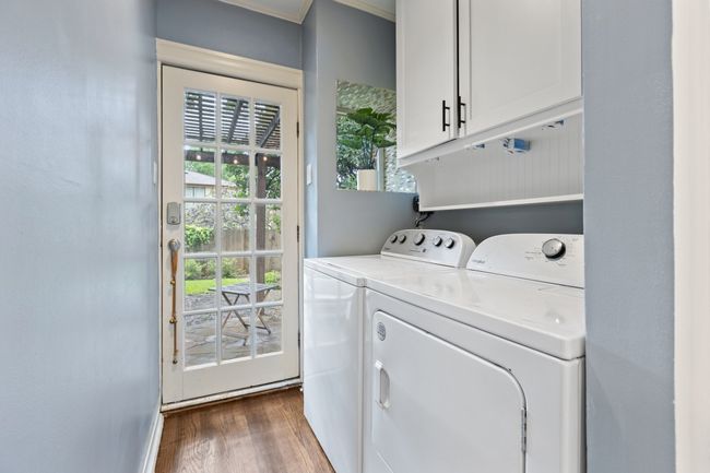 Utility room attached to kitchen with direct backyard access and additional storage space | Image 21