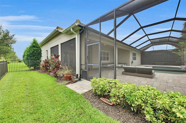 lanai from outside/ dog run fenced in | Image 62