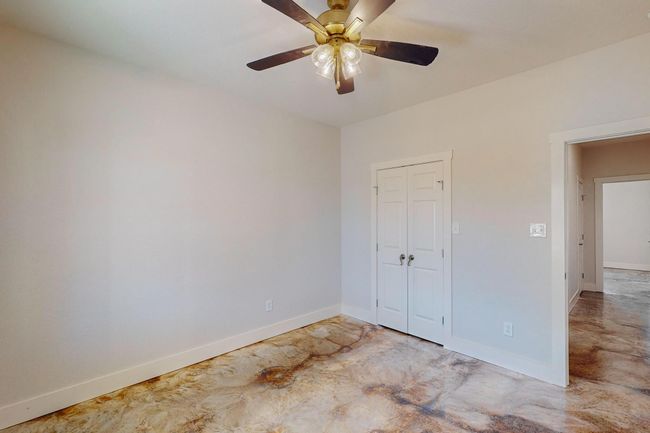 Empty room featuring a ceiling fan and concrete floors | Image 19