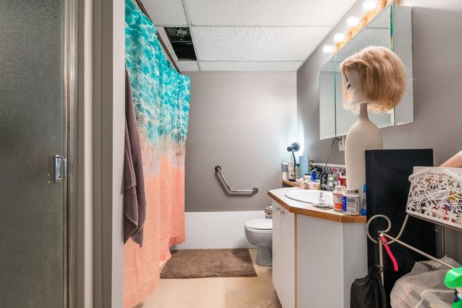 Full bath with a shower with shower curtain, toilet, vanity, and a paneled ceiling | Image 30